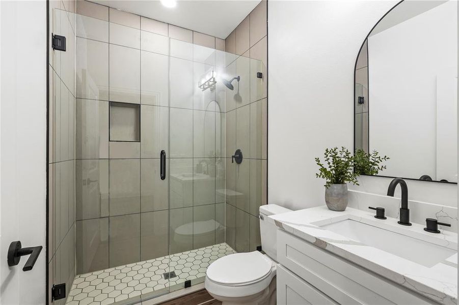 Bathroom featuring a shower stall and vanity
