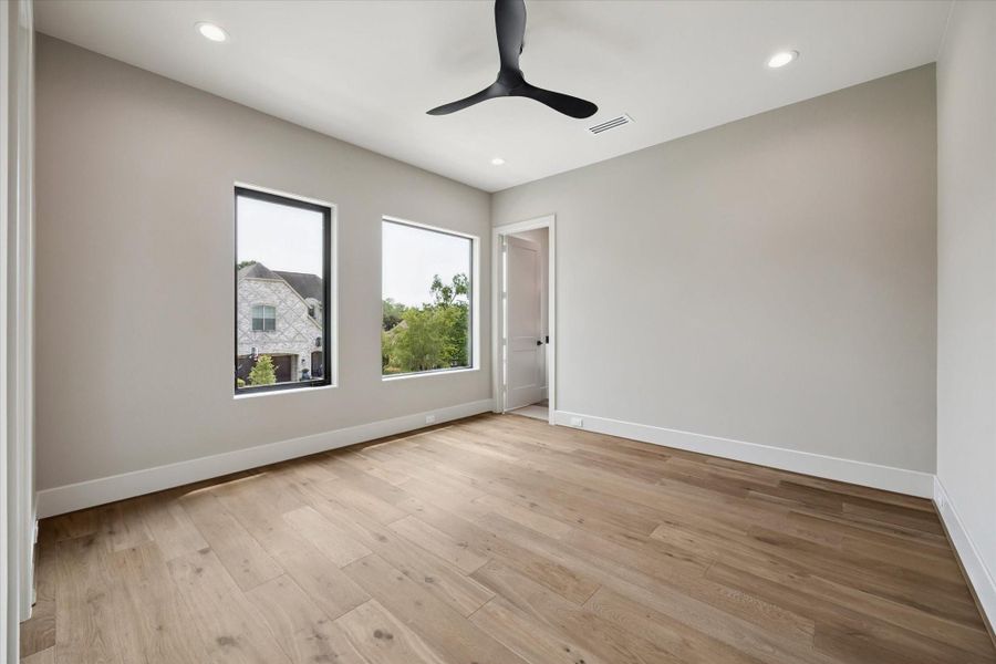 Generously sized, the secondary bedroom includes a walk-in closet enhanced with built-in cabinetry to keep everything neatly arranged.