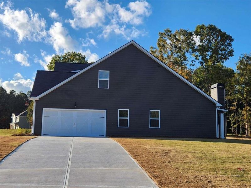 Front exterior of a new home in The Woodlands Preserve, Jackson, GA, highlighting curb appeal (Image 18).