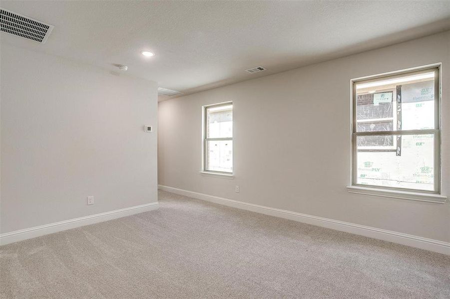 Spare room with light carpet and recessed lighting