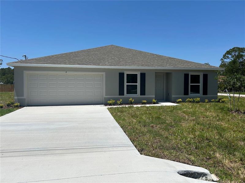 Front exterior of a new home in Palm Coast: Value Collection, Palm Coast, FL, highlighting curb appeal (Image 1). Front exterior of a new home in Palm Coast: Value Collection, Palm Coast, FL, highlighting curb appeal (Image 1).