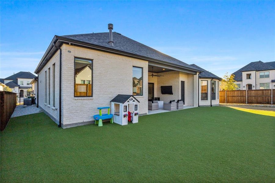the majority of the back yard is turf, with side yards having stone or real grass