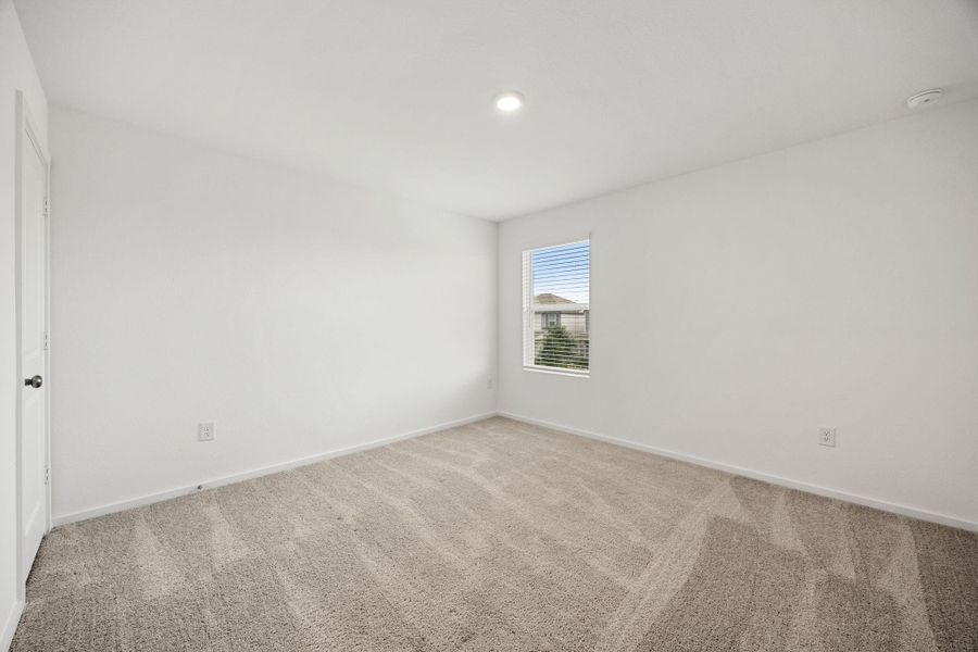 Another well-sized secondary bedroom with a functional layout and abundant natural light, perfect for family members or guests.