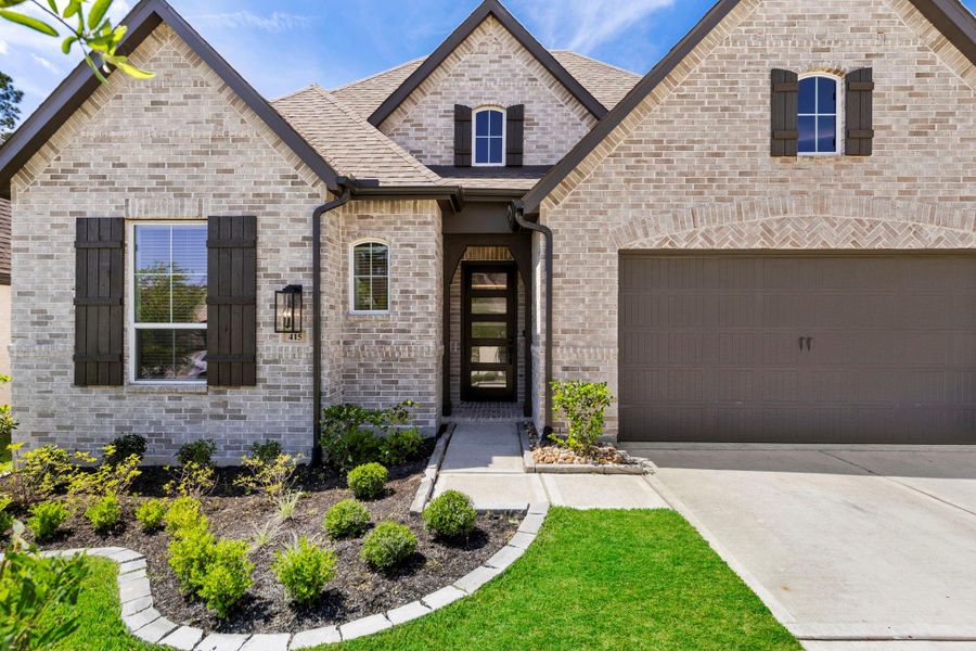 Front exterior of a new home in Woodforest, Montgomery, TX, highlighting curb appeal (Image 26).