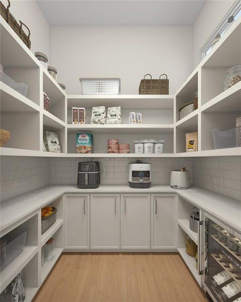 The spacious walk-in pantry designed for ultimate organization! With plenty of storage, built-in shelving, and counter space for small appliances, this pantry is perfect for keeping everything in its place.