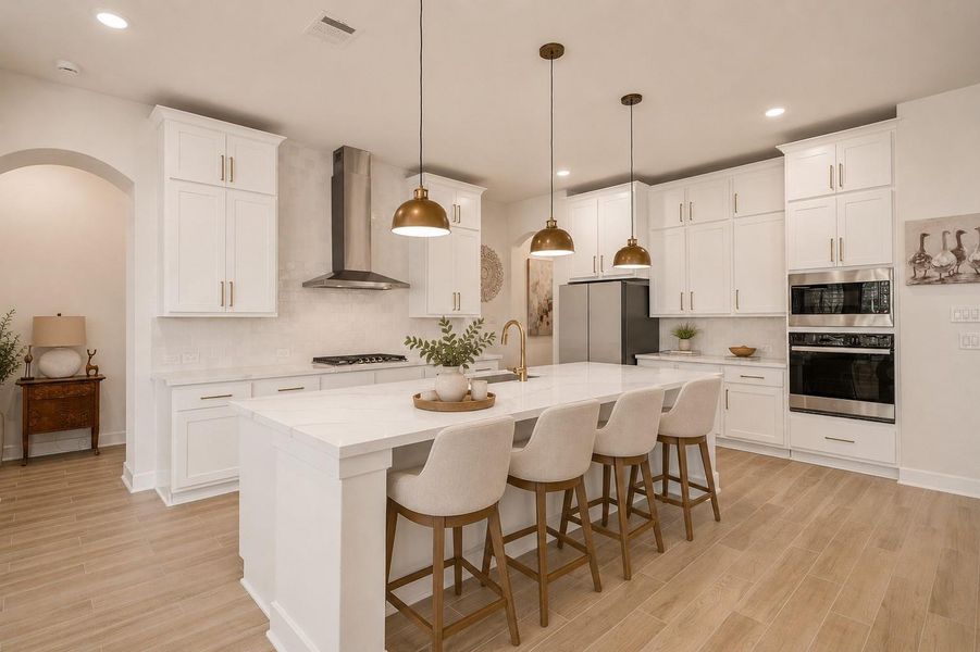 This modern kitchen features sleek white cabinetry, a large island with seating for four, stainless steel appliances, and stylish pendant lighting. The open layout and wood-look flooring create a welcoming feel. This modern kitchen features sleek white cabinetry, a large island with seating for four, stainless steel appliances, and stylish pendant lighting. The open layout and wood-look flooring create a welcoming feel.