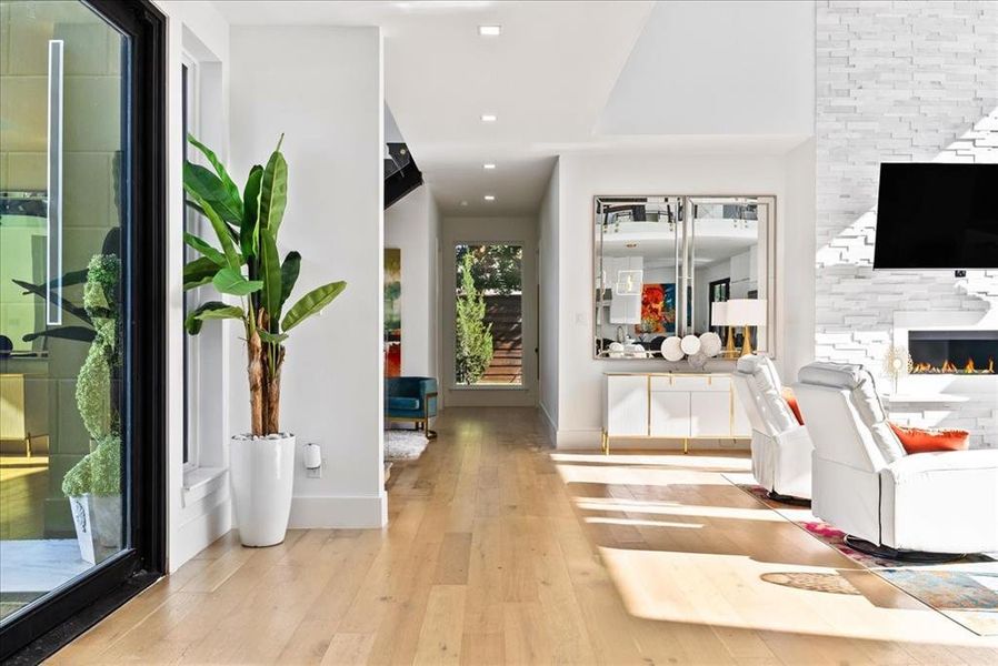 Foyer entrance with light hardwoods and extra sitting area