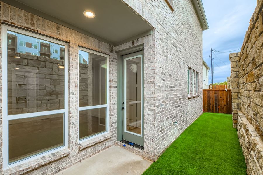 Exterior details and patio area of a home in Castle Hills Northpointe - Townhomes, Lewisville (Image 4).