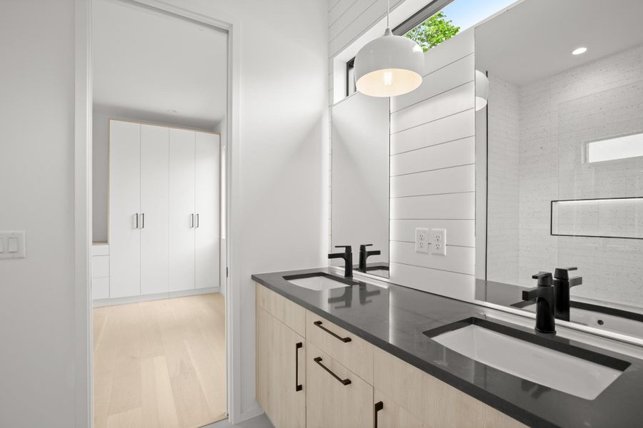 Bathroom featuring double vanity and a shower