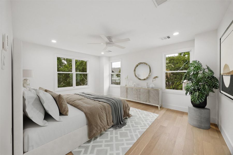 Natural light fills the primary suite through multiple oversized windows overlooking surrounding greenery near Marmion Park. Soft neutral finishes and the room’s quieter positioning within the home create a more relaxed and private atmosphere. (digitally staged)