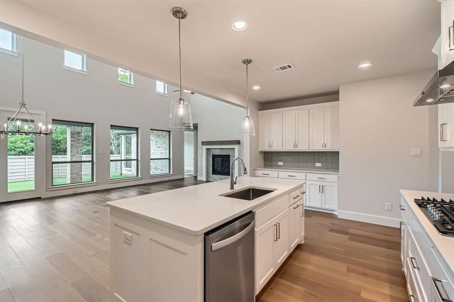 Kitchen with appliances with stainless steel finishes, light wood-style flooring, open floor plan, light countertops, and recessed lighting Kitchen with appliances with stainless steel finishes, light wood-style flooring, open floor plan, light countertops, and recessed lighting