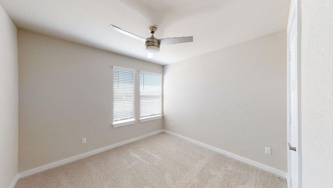 Unfurnished room with light carpet and a ceiling fan