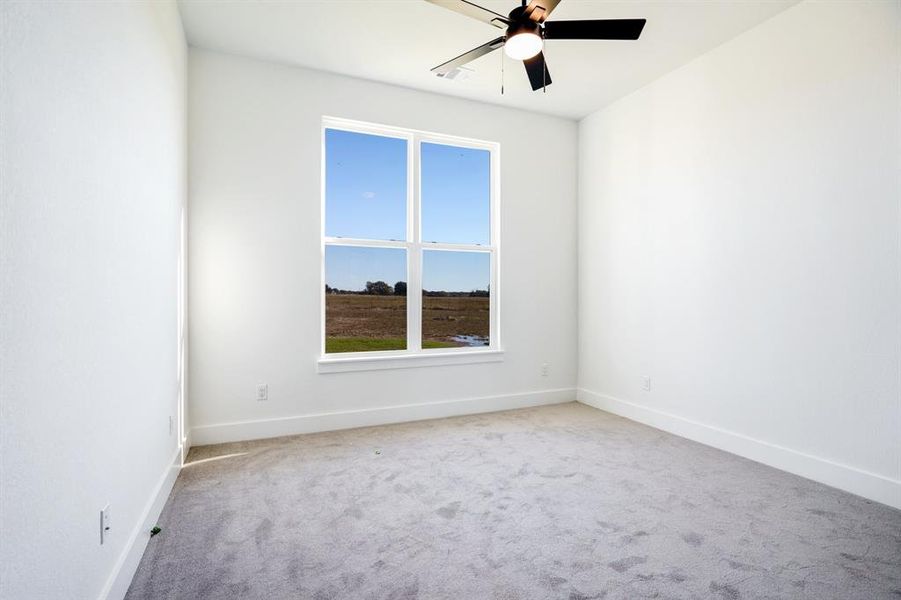 Unfurnished room featuring light carpet and ceiling fan