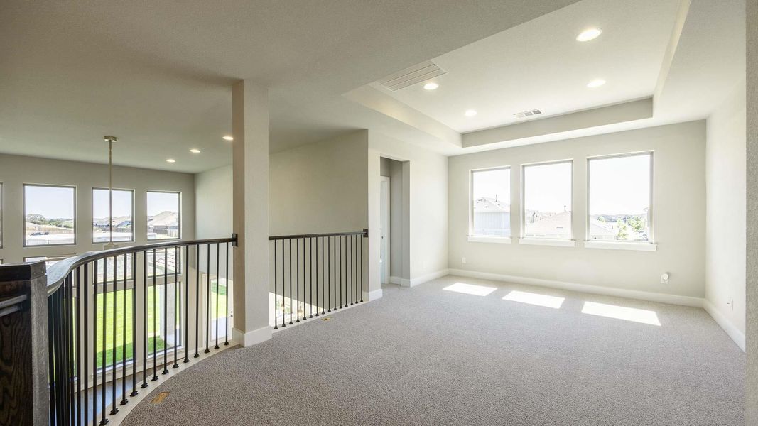 Unfurnished room featuring healthy amount of natural light, recessed lighting, carpet, and a raised ceiling Unfurnished room featuring healthy amount of natural light, recessed lighting, carpet, and a raised ceiling