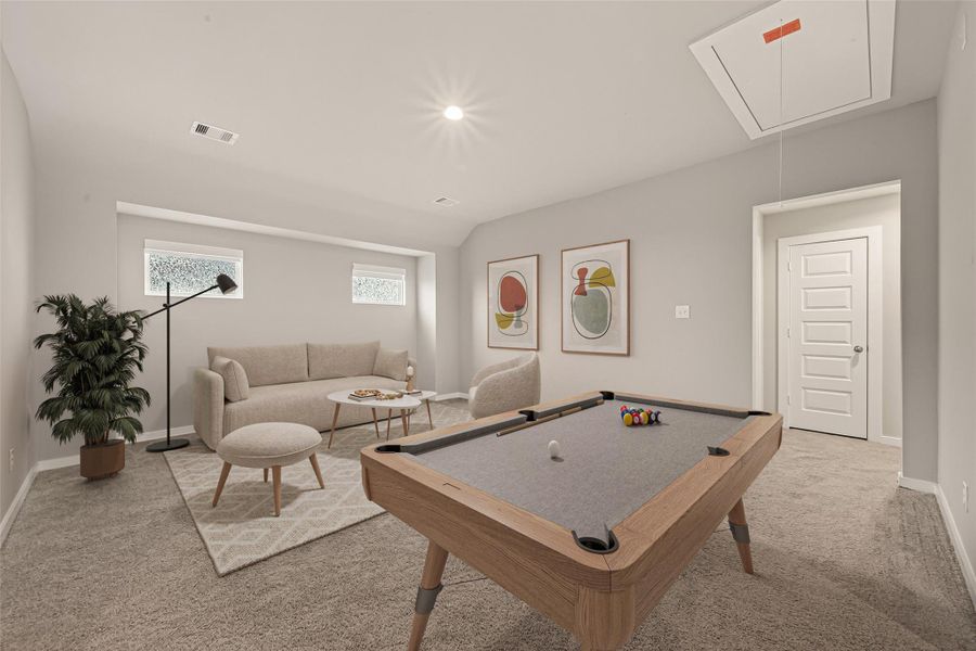 The second floor features a spacious game room with carpeted flooring, providing a comfortable area for activities and gatherings. (Virtually Staged)