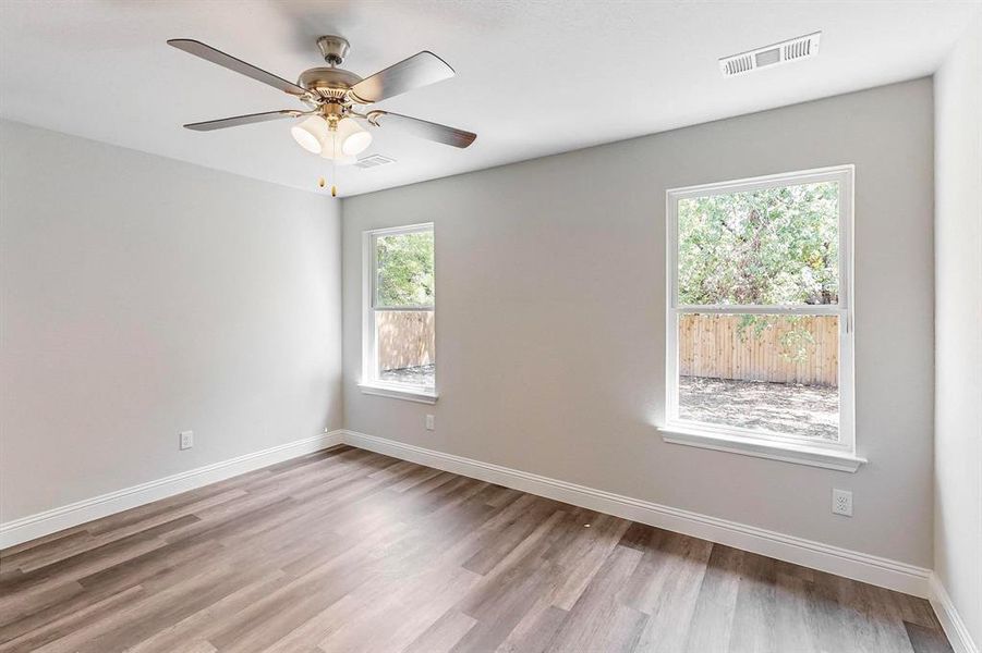 Spare room featuring ceiling fan and light wood-type flooring