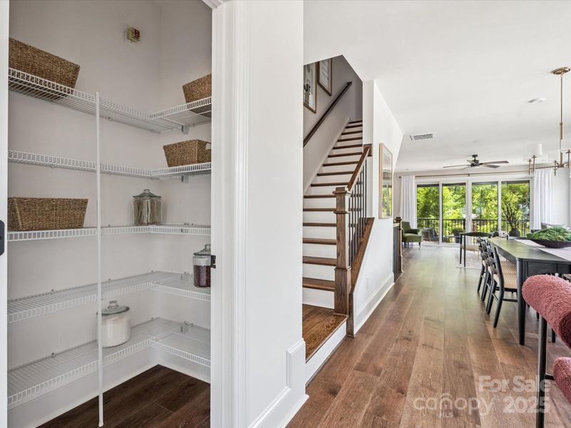 Large walk-in pantry and open rail leading to third floor. Not pictured: upgraded wood pantry shelving. *Model Photos | Actual finishes, structural selections, and orientation may vary. Large walk-in pantry and open rail leading to third floor. Not pictured: upgraded wood pantry shelving. *Model Photos | Actual finishes, structural selections, and orientation may vary.
