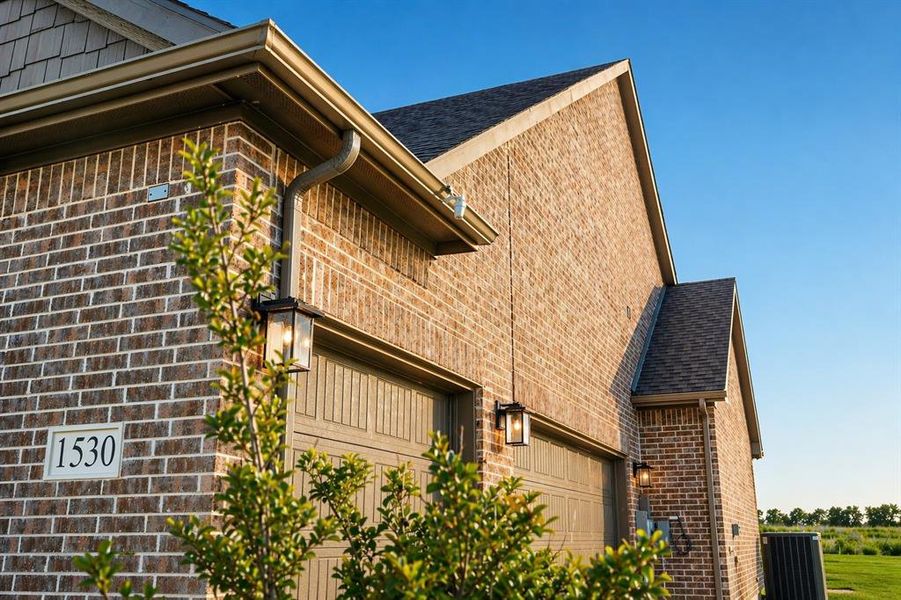 Brick exterior with contrasting trim and architectural shingles