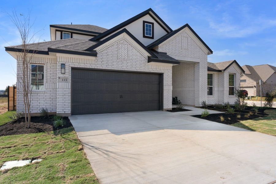 Front exterior of a new home in Highland Village, Georgetown, TX, highlighting curb appeal (Image 14).