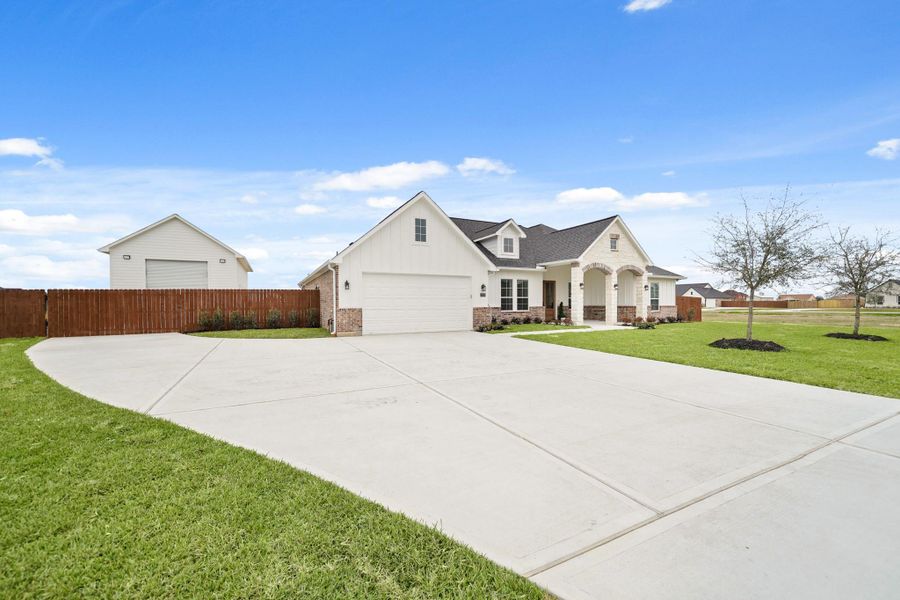 Front exterior of a new home in Blue Jay's Landing, Needville, TX, highlighting curb appeal (Image 1).