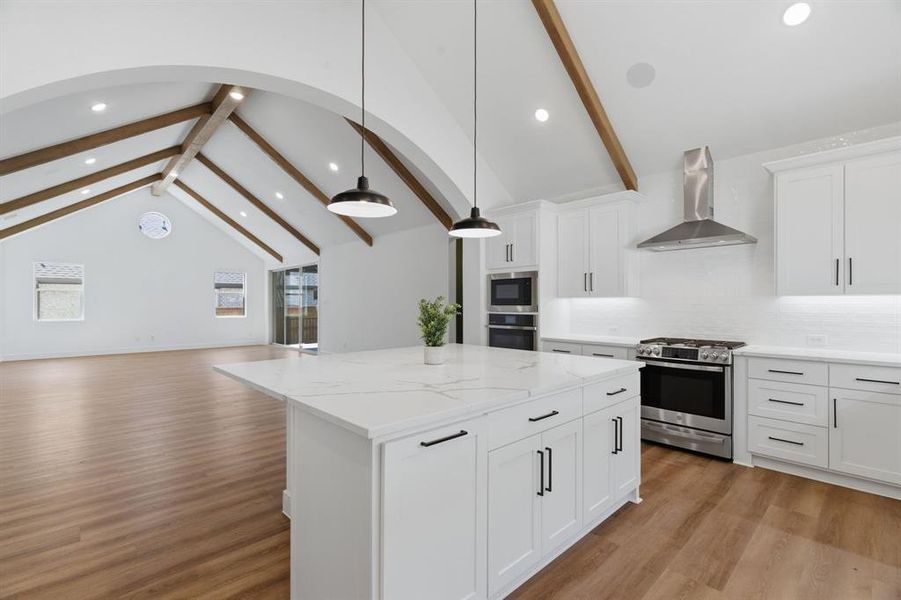 Kitchen island with a white quartz countertop and integrated seating area Kitchen island with a white quartz countertop and integrated seating area