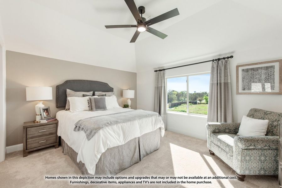 Bedroom with vaulted ceiling, ceiling fan, king bed, and large window with natural light