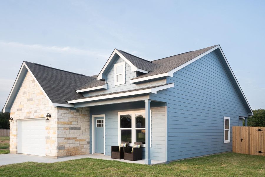 View of front of property with a shingled roof, an attached garage, and stone siding View of front of property with a shingled roof, an attached garage, and stone siding