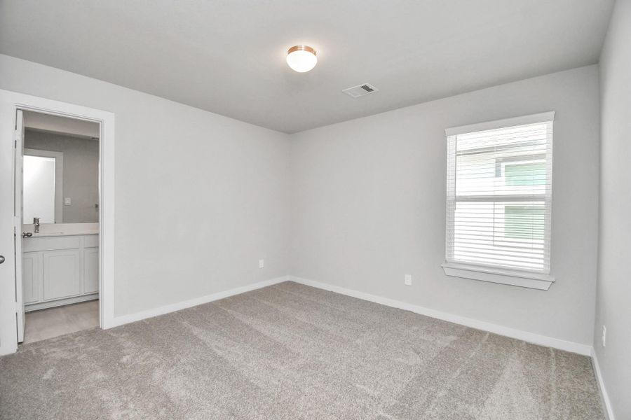 Generously sized secondary bedrooms featuring spacious closets, soft and inviting carpeting underfoot, large windows allowing plenty of natural light, and the added touch of privacy blinds for your personal retreat. Sample photo of completed home with similar floor plan. Actual colors and selections may vary.