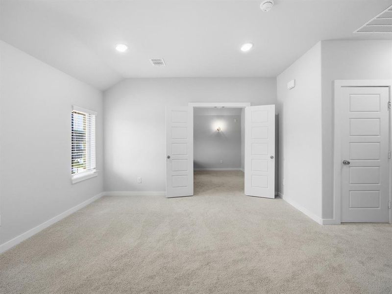 Unfurnished bedroom with light carpet and recessed lighting