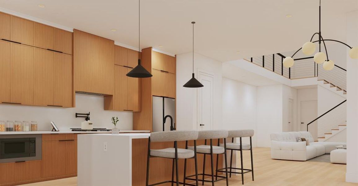 Kitchen with decorative light fixtures, a center island with sink, stainless steel appliances, light wood-style flooring, and a kitchen breakfast bar