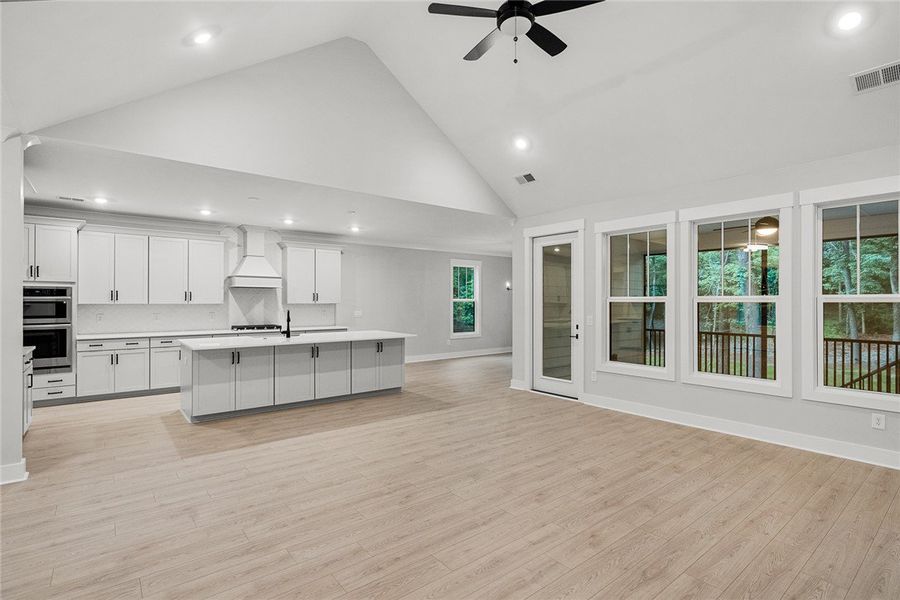 A luminous open-concept living area with soaring v A luminous open-concept living area with soaring v