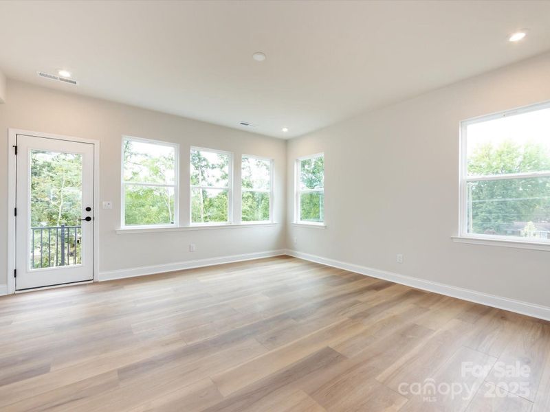 Great Room Surrounded by Natural Light Leading to Outdoor Living