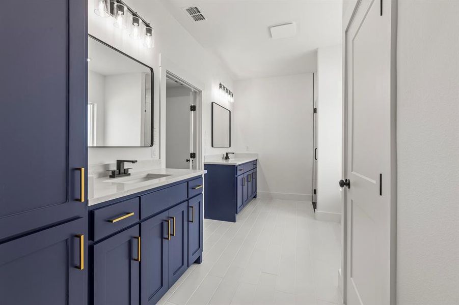 Bathroom with two vanities and baseboards