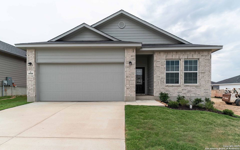 Front exterior of a new home in Hickory Ridge, Elmendorf, TX, highlighting curb appeal (Image 1). Front exterior of a new home in Hickory Ridge, Elmendorf, TX, highlighting curb appeal (Image 1).