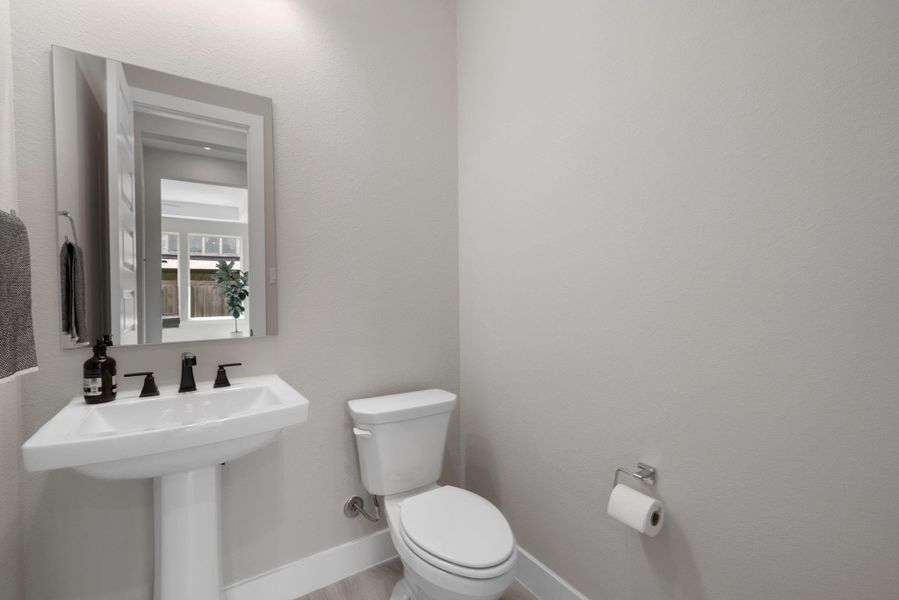 The home includes a thoughtfully designed half bathroom, located in the garage area, offering both style and convenience. The home includes a thoughtfully designed half bathroom, located in the garage area, offering both style and convenience.