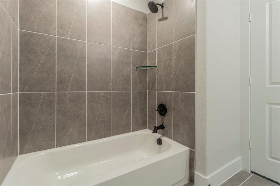 Bathroom featuring shower / washtub combination and tile patterned floors