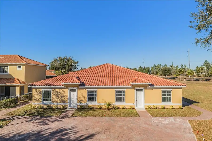 Front exterior of a new home in , Poinciana, FL, highlighting curb appeal (Image 1). Front exterior of a new home in , Poinciana, FL, highlighting curb appeal (Image 1).