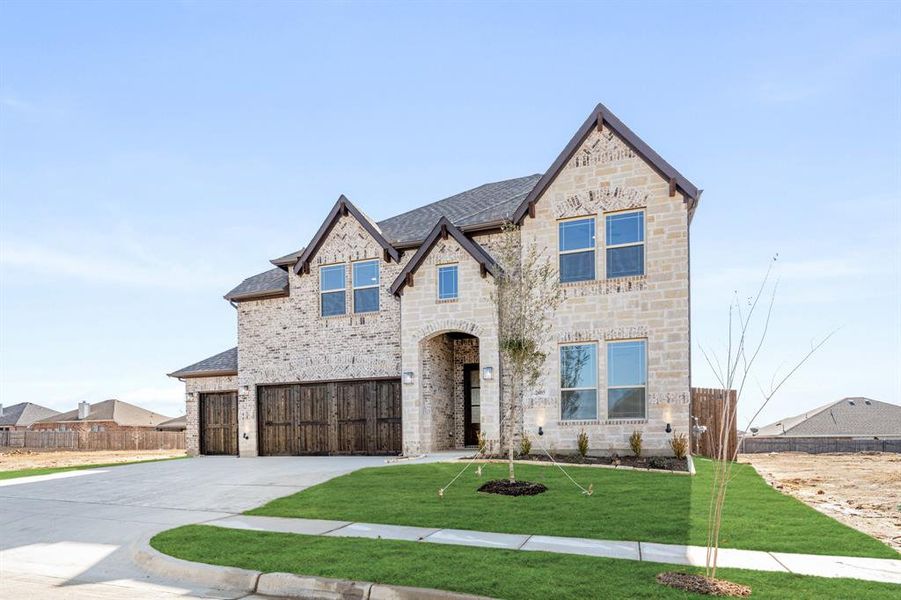 Front exterior of a new home in Parks at Panchasarp Farms, Burleson, TX, highlighting curb appeal (Image 26). Front exterior of a new home in Parks at Panchasarp Farms, Burleson, TX, highlighting curb appeal (Image 26).