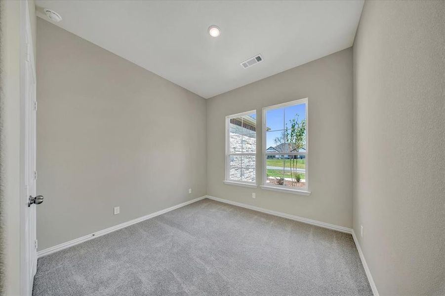 Unfurnished room featuring carpet floors and a smoke detector Unfurnished room featuring carpet floors and a smoke detector