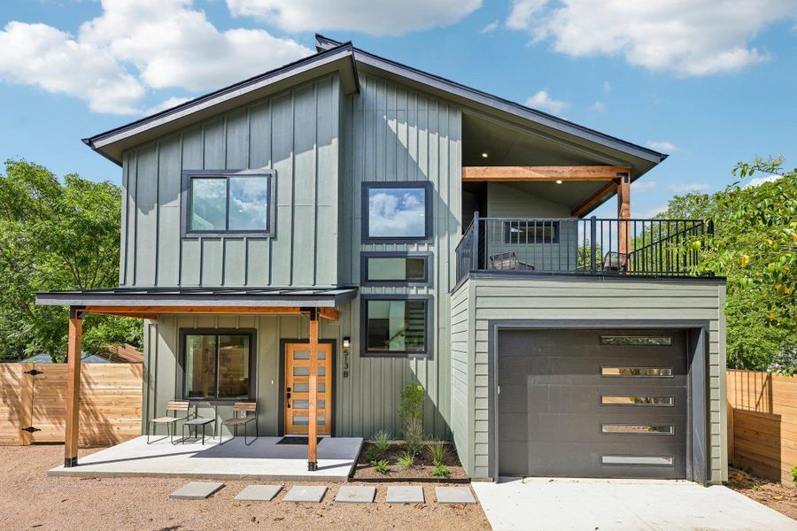 An iconic stack of windows over the stairs define this contemporary two-story home, complete with an integrated garage and upper-level balcony. An iconic stack of windows over the stairs define this contemporary two-story home, complete with an integrated garage and upper-level balcony.