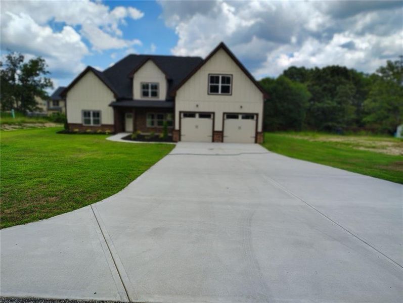 Front exterior of a new home in , Loganville, GA, highlighting curb appeal (Image 23). Front exterior of a new home in , Loganville, GA, highlighting curb appeal (Image 23).