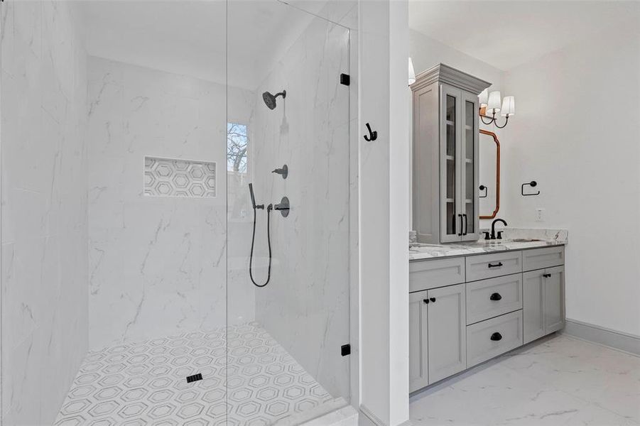 Bathroom with a tile shower and vanity