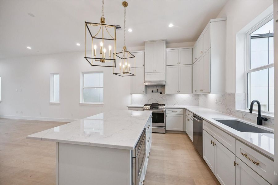 Shaker-style designer cabinets with soft-close drawers and stunning quartz countertops.