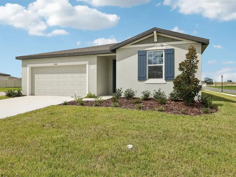 Front exterior of a new home in The Reserve at Van Oaks, Auburndale, FL, highlighting curb appeal (Image 2). Front exterior of a new home in The Reserve at Van Oaks, Auburndale, FL, highlighting curb appeal (Image 2).