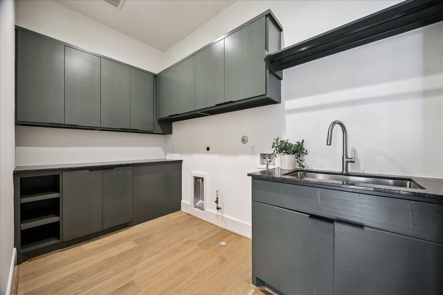Laundry room offers custom built-ins and a sink. Laundry room offers custom built-ins and a sink.