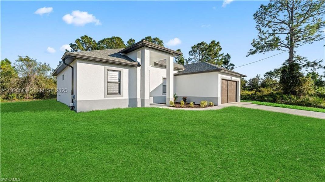 Front exterior of a new home in , Lehigh Acres, FL, highlighting curb appeal (Image 25).
