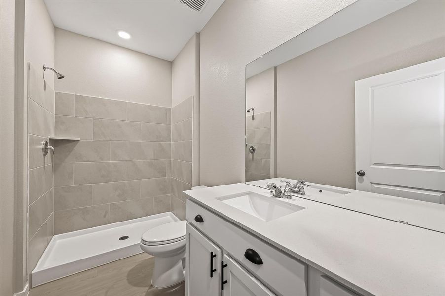Guest suite full bathroom featuring a tub and shower combination, vanity with storage, and bright neutral finishes. Guest suite full bathroom featuring a tub and shower combination, vanity with storage, and bright neutral finishes.