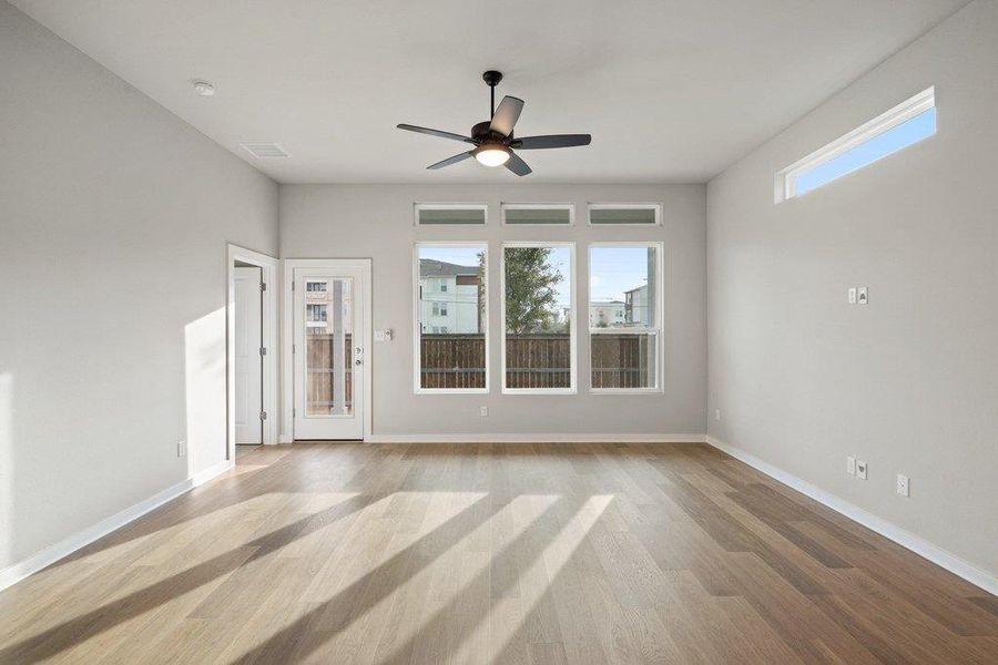 Spare room with ceiling fan and light wood-style flooring