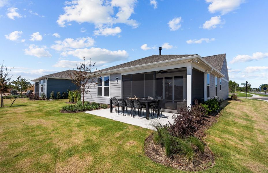 Large Screened in Patio and additional outdoor dining space and yard. Model Home Representation.