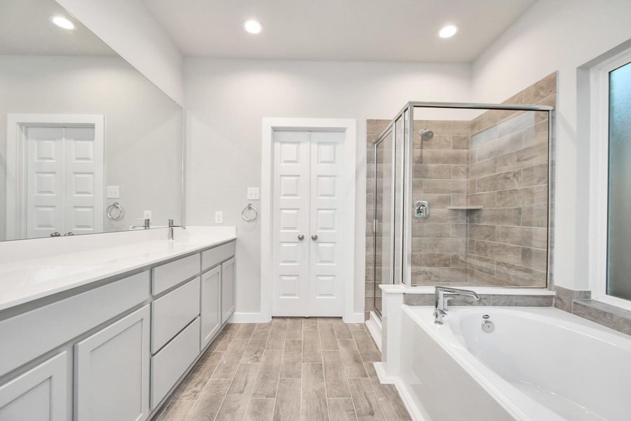 The primary en-suite has a soaking tub to give you that spa experience. The large privacy window allow lots of nature light in the space. Sample photo of completed home with similar floor plan. As-built interior colors and selections may vary. The primary en-suite has a soaking tub to give you that spa experience. The large privacy window allow lots of nature light in the space. Sample photo of completed home with similar floor plan. As-built interior colors and selections may vary.